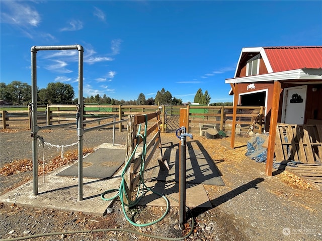 view of play area featuring a rural view and an outdoor structure