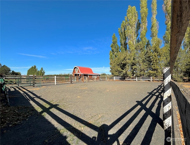 view of yard with a rural view and an outbuilding