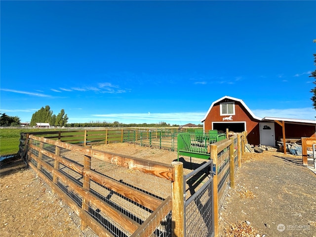 view of yard with a rural view and an outdoor structure