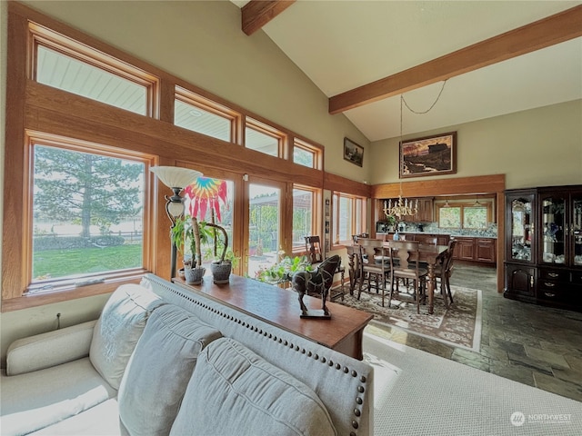 living room featuring beamed ceiling, a healthy amount of sunlight, and high vaulted ceiling