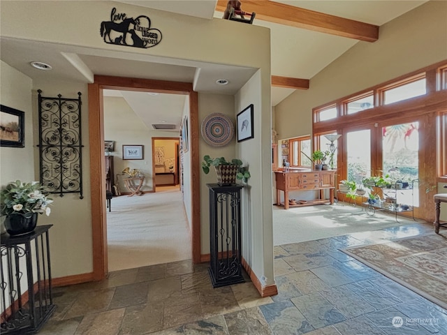 hallway with french doors, carpet, and lofted ceiling with beams