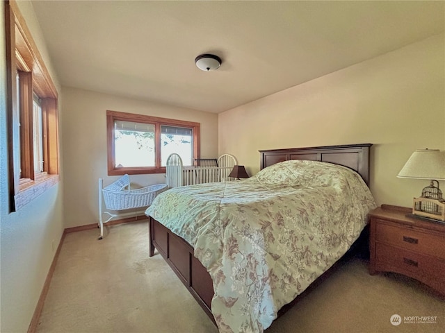 bedroom featuring light colored carpet