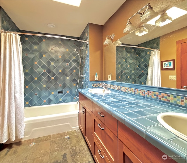 bathroom with decorative backsplash, shower / bath combination with curtain, and vanity