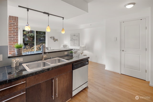 kitchen with sink, light wood-type flooring, dark brown cabinets, pendant lighting, and dishwasher