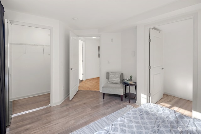 bedroom with wood-type flooring and a closet