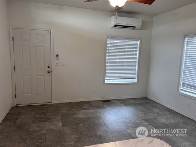 interior space featuring ceiling fan and a wall mounted AC