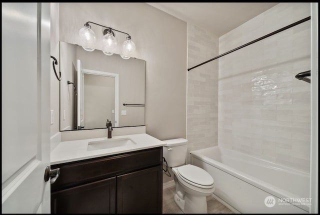 full bathroom featuring toilet, vanity, and tiled shower / bath