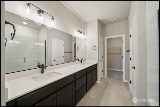 bathroom featuring walk in shower, tile patterned flooring, and vanity