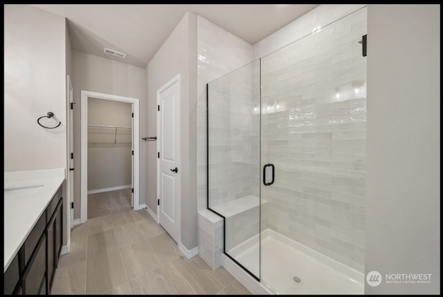 bathroom featuring vanity and an enclosed shower