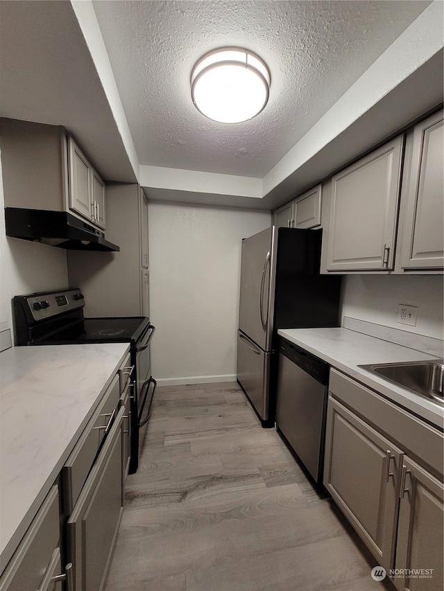 kitchen with electric range, dishwasher, light hardwood / wood-style floors, a textured ceiling, and gray cabinets