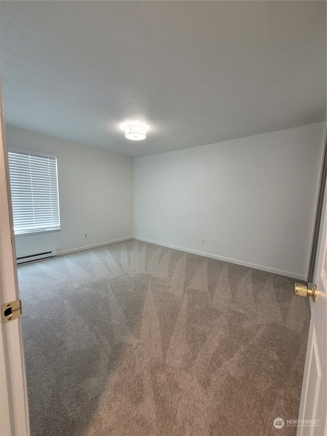 unfurnished room with carpet, a baseboard radiator, and a textured ceiling