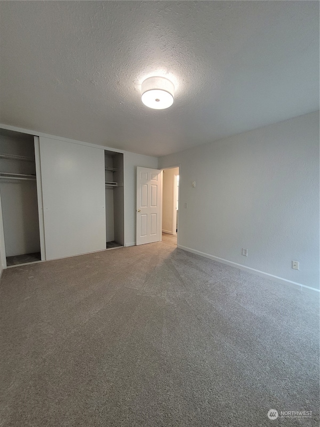 unfurnished bedroom featuring carpet and a textured ceiling