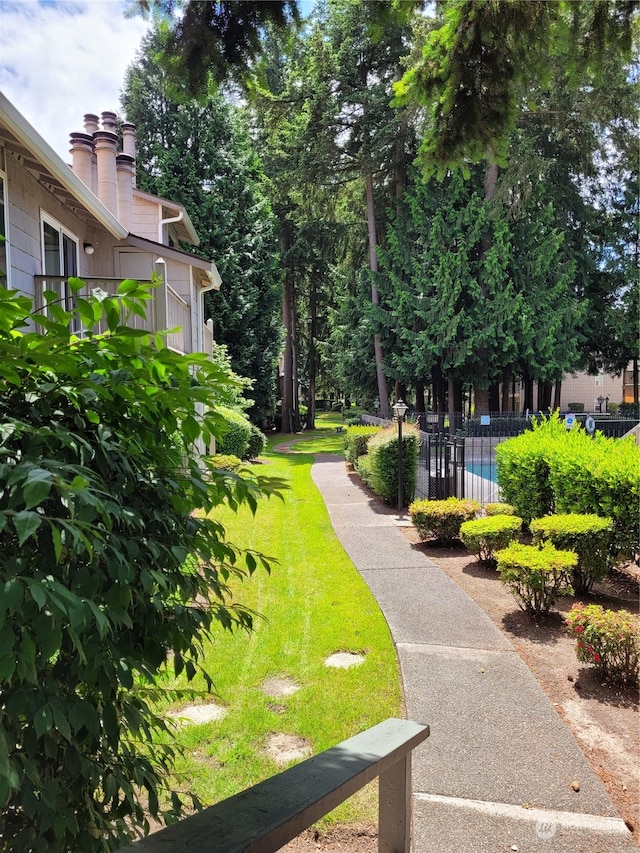 surrounding community featuring a yard and a swimming pool