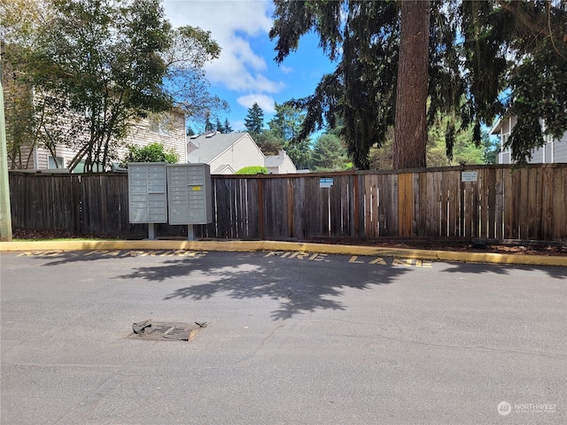 view of vehicle parking featuring mail boxes