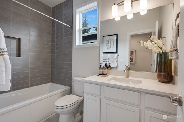 full bathroom with vanity, toilet, and tiled shower / bath combo