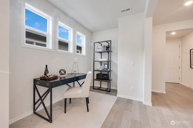 office with light hardwood / wood-style flooring