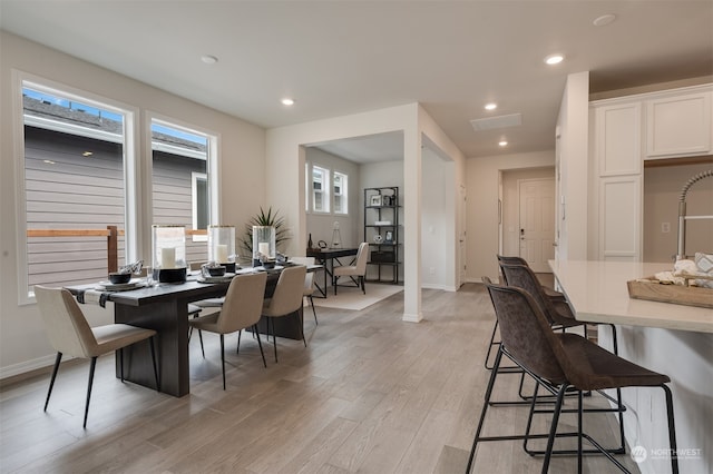 dining area with light hardwood / wood-style floors