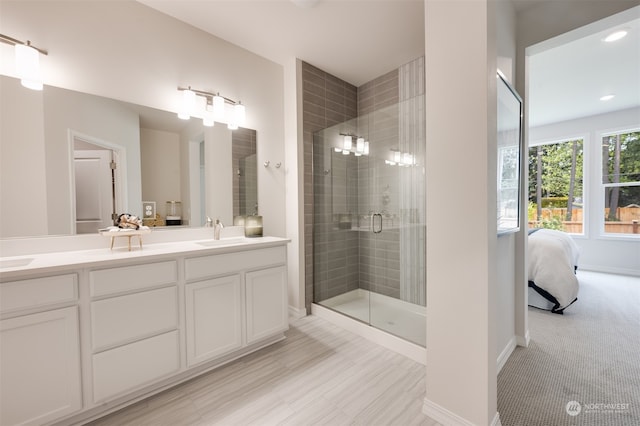 bathroom featuring vanity and a shower with shower door