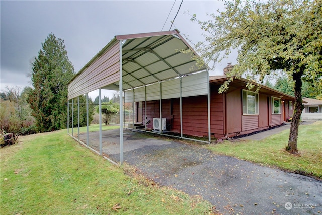 view of outbuilding with a yard and a carport