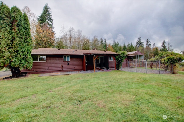 rear view of house featuring a yard