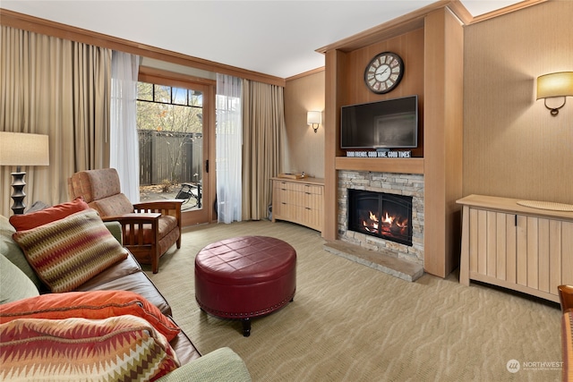 living room with a fireplace, light colored carpet, and crown molding