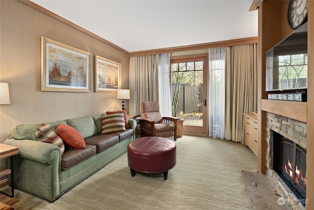 living room featuring a stone fireplace, crown molding, and light colored carpet