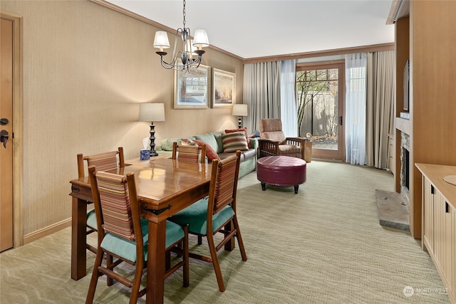 dining area featuring ornamental molding, light colored carpet, and an inviting chandelier