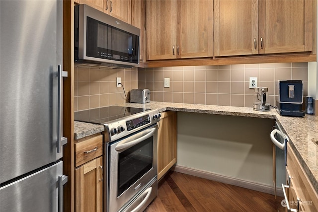 3600 Suncadia Trl Unit 2006, Cle Elum, WA 98922 - kitchen featuring stainless steel appliances, backsplash, dark wood-type flooring, light stone countertops, and brown cabinetry