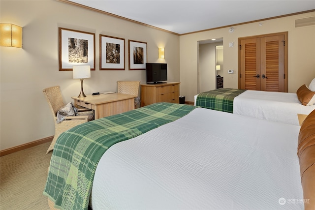 carpeted bedroom featuring a closet and ornamental molding