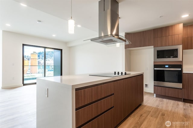 kitchen with island range hood, modern cabinets, oven, black electric stovetop, and built in microwave