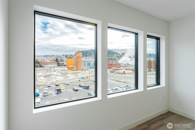 interior space featuring wood finished floors and baseboards