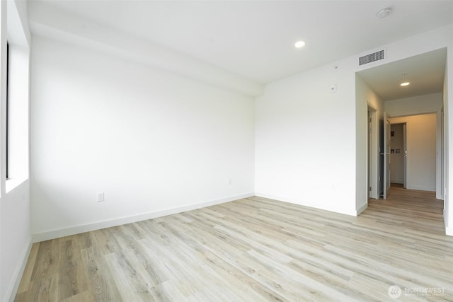 spare room featuring recessed lighting, visible vents, light wood-style flooring, and baseboards