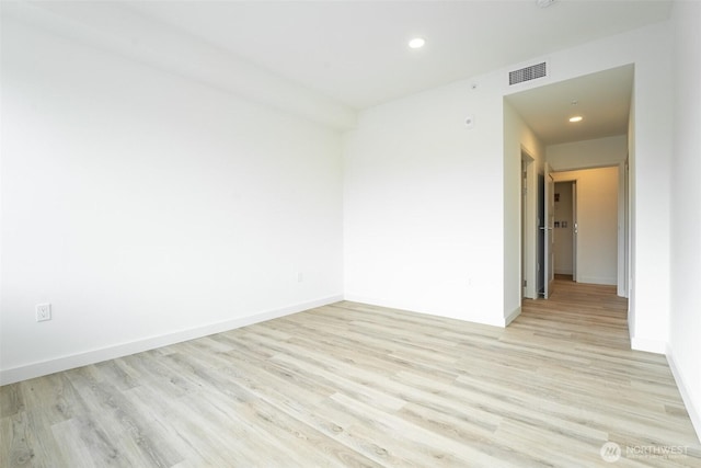 empty room featuring baseboards, recessed lighting, visible vents, and light wood-style floors