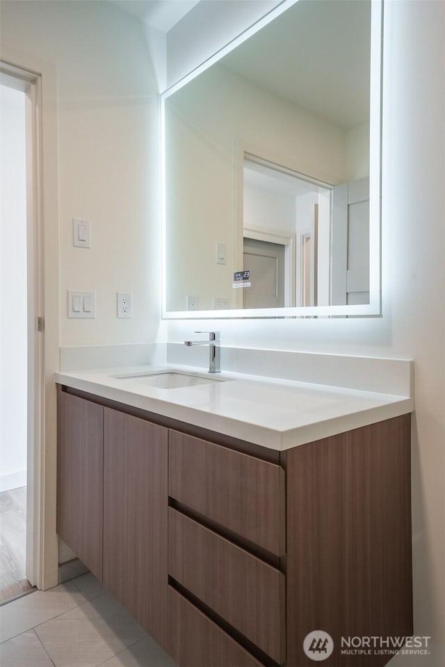 bathroom with tile patterned flooring and vanity