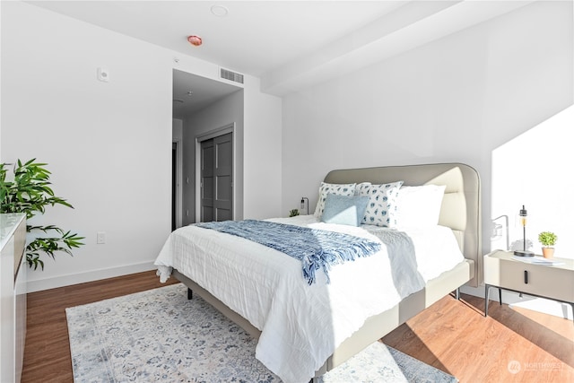 bedroom with hardwood / wood-style floors