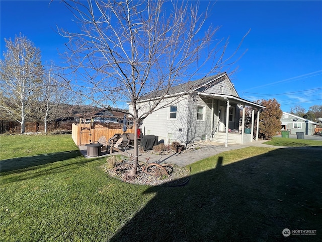 rear view of house featuring a lawn and a patio area