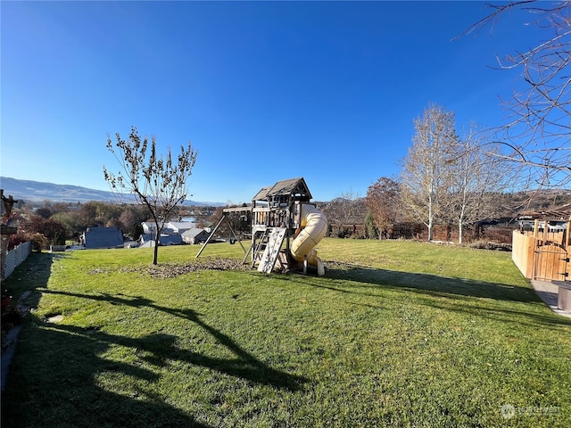 view of yard with a playground and a mountain view