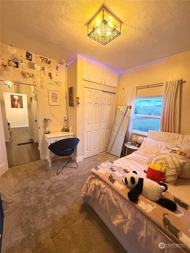 bedroom with carpet, a water view, a textured ceiling, and a closet