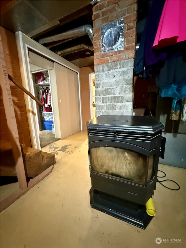 misc room featuring concrete floors and a wood stove