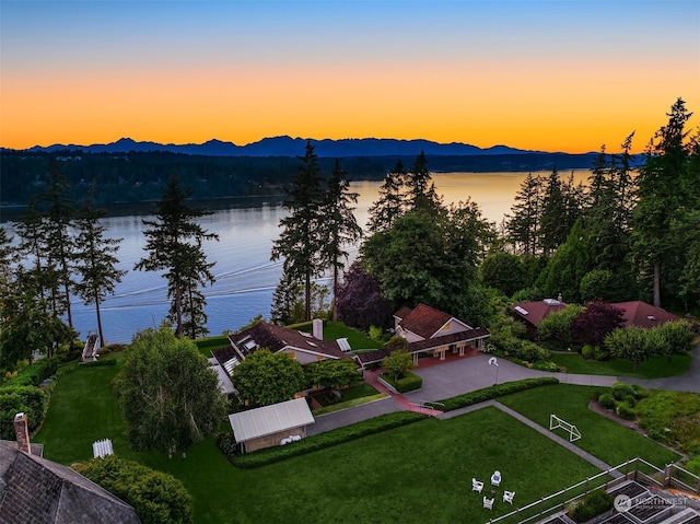 aerial view at dusk with a water and mountain view