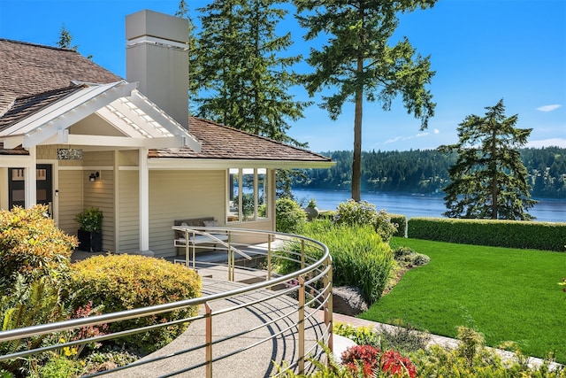 exterior space featuring a yard and a water view