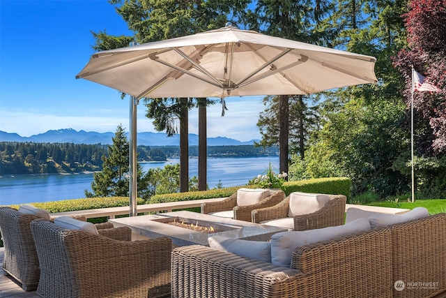 view of patio featuring a water and mountain view