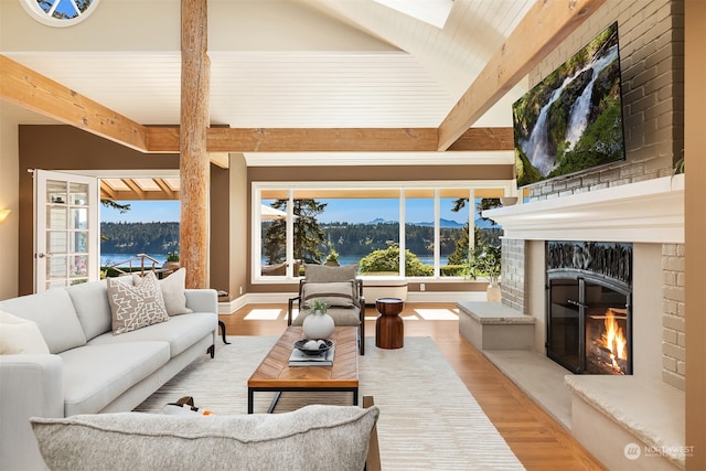 living room with light hardwood / wood-style flooring and beam ceiling