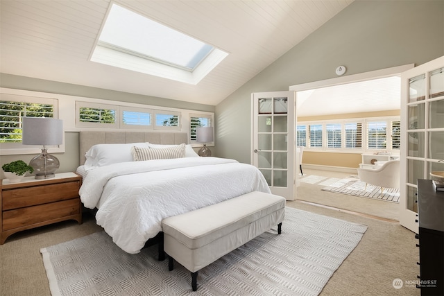 carpeted bedroom featuring vaulted ceiling with skylight and wooden ceiling