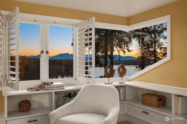 sitting room featuring built in desk and a water and mountain view