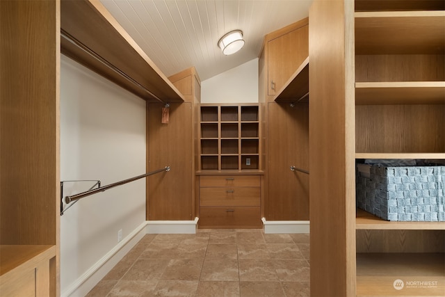 walk in closet featuring vaulted ceiling