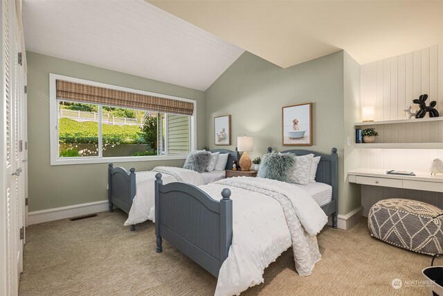 bedroom featuring lofted ceiling and light colored carpet