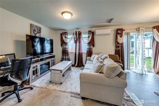 living room featuring a wall mounted air conditioner and hardwood / wood-style flooring