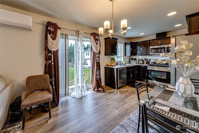 kitchen featuring light wood-style flooring, dark brown cabinetry, stainless steel appliances, light countertops, and a wall mounted AC