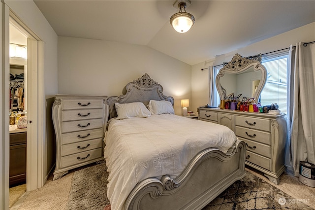 carpeted bedroom featuring lofted ceiling